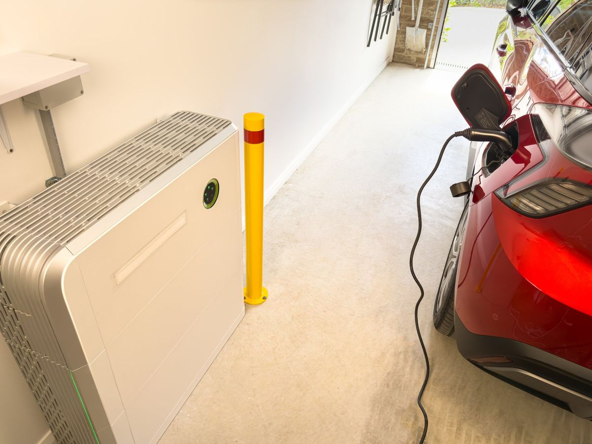 Electric car plugged in and charging in a home garage