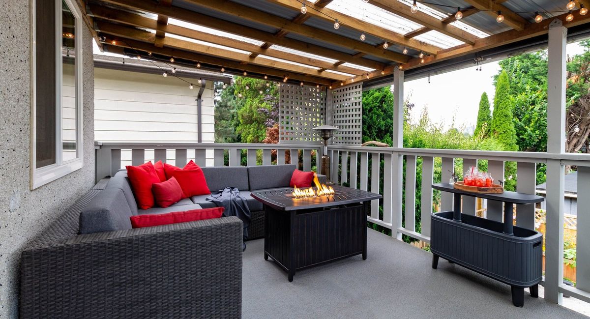 Covered back porch with string lights over an outdoor seating area